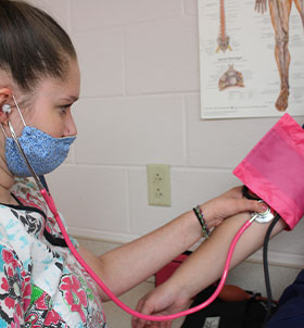 Student taking blood pressure reading